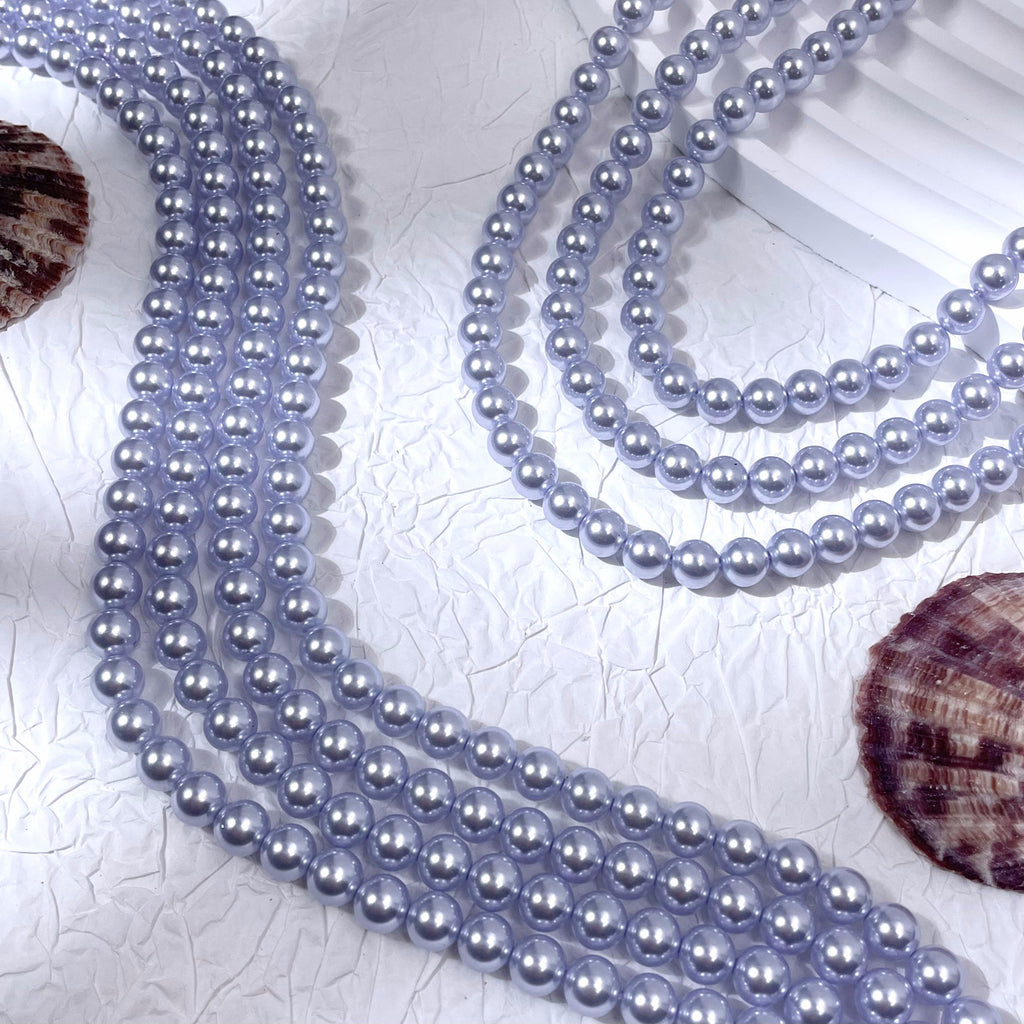 Multiple strands of light lavender-gray glass pearl beads with seashells