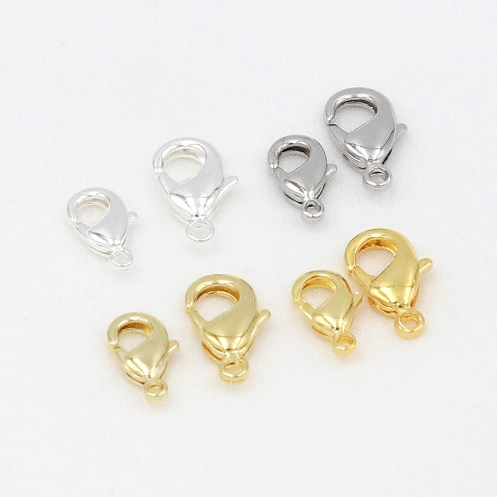 Gold and silver teardrop lobster clasps in assorted sizes on white background