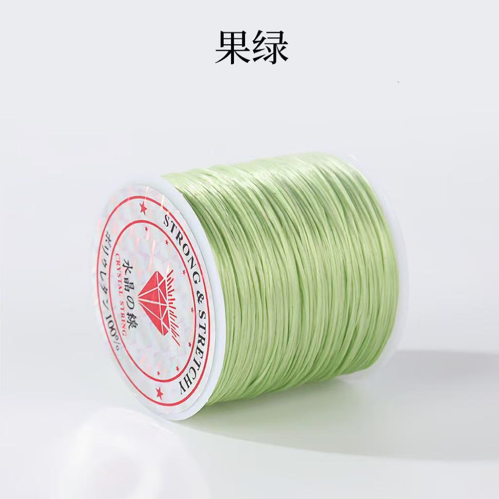 Spool of light green 0.8mm flat elastic beading cord, Chinese characters above, red diamond label, white background