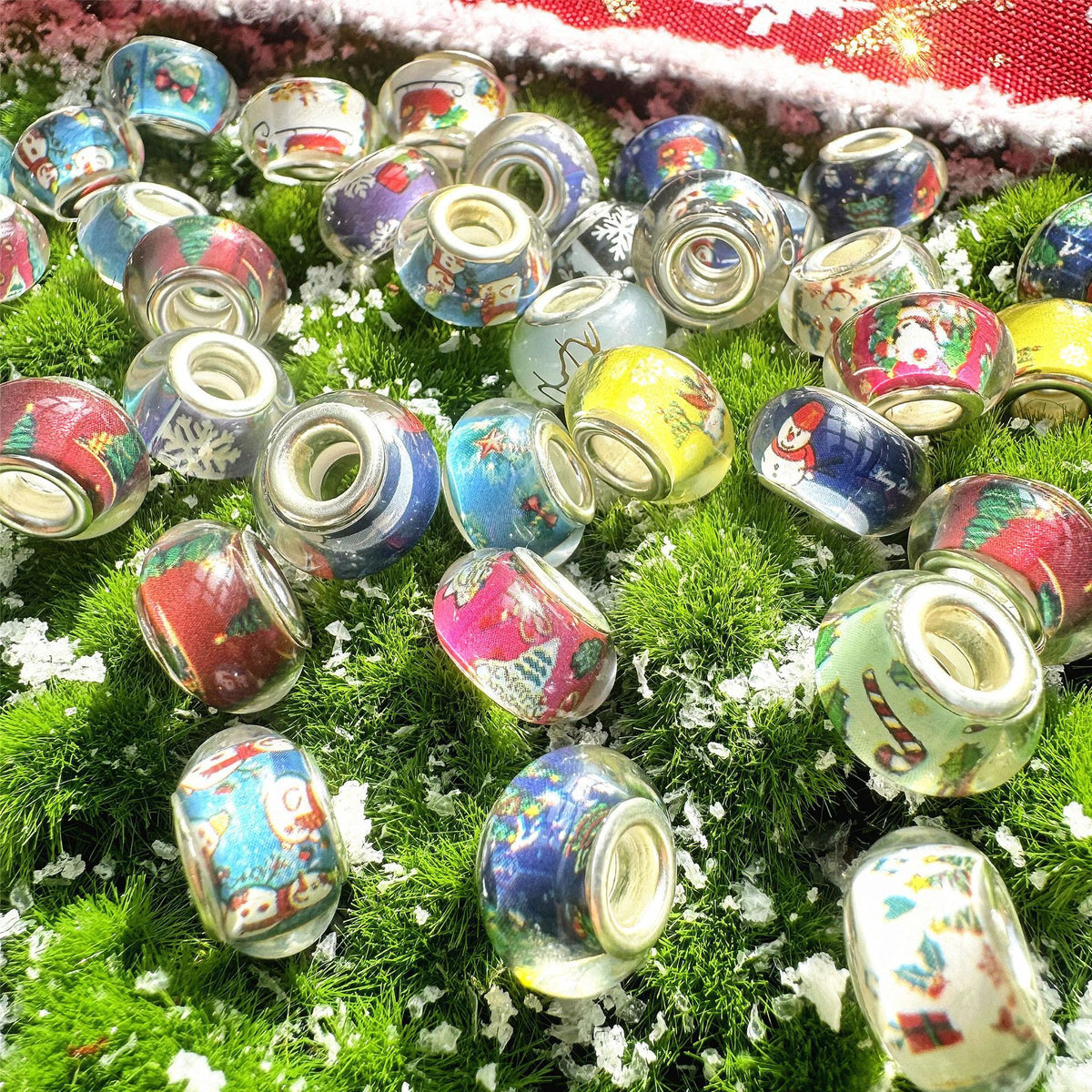Pile of small clear acrylic beads with colorful Christmas illustrations