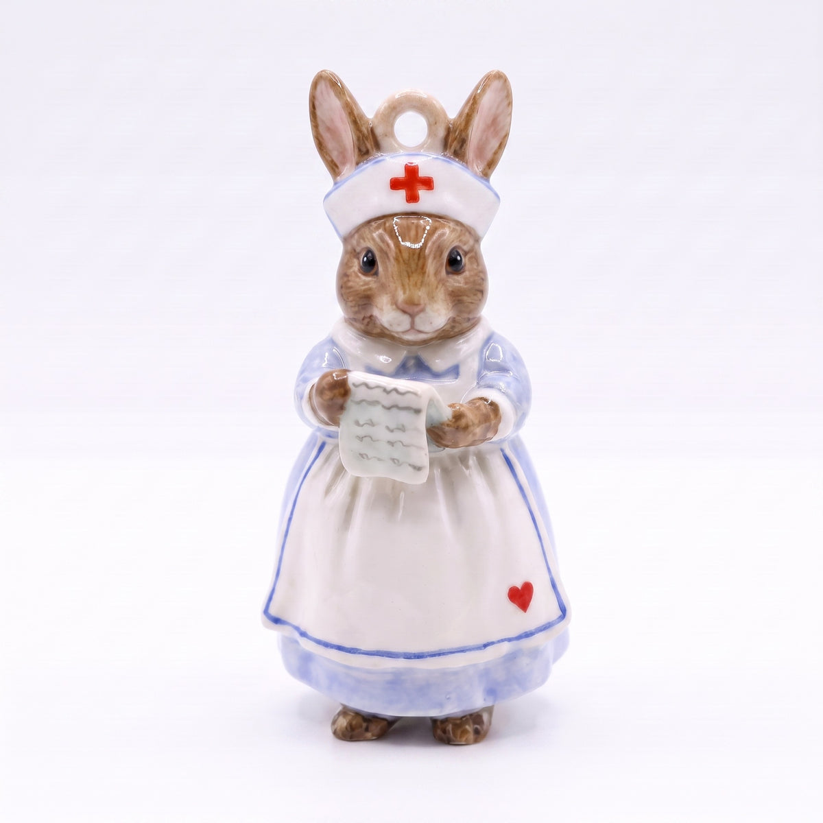 3D rabbit pendant charm dressed as nurse, holding paper sheet, wearing white dress.