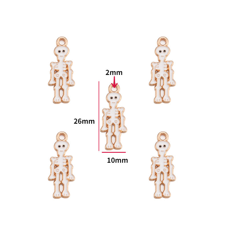 Five small skeleton-shaped jewelry charms on a white background