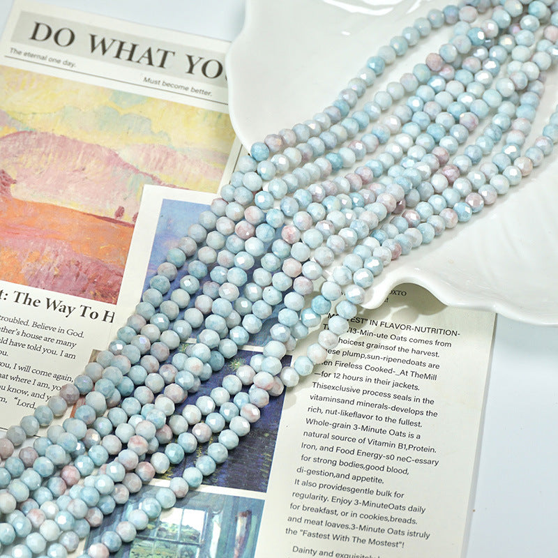 Close-up of pale blue, white, and soft pink faceted porcelain bead strand