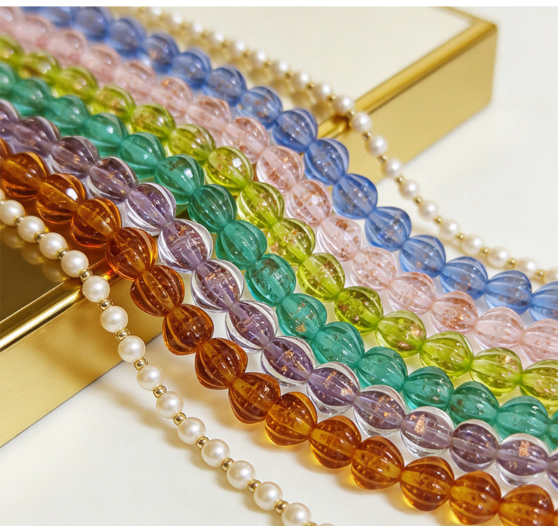 Strands of translucent lantern glass beads in amber, purple, green, blue, and pink