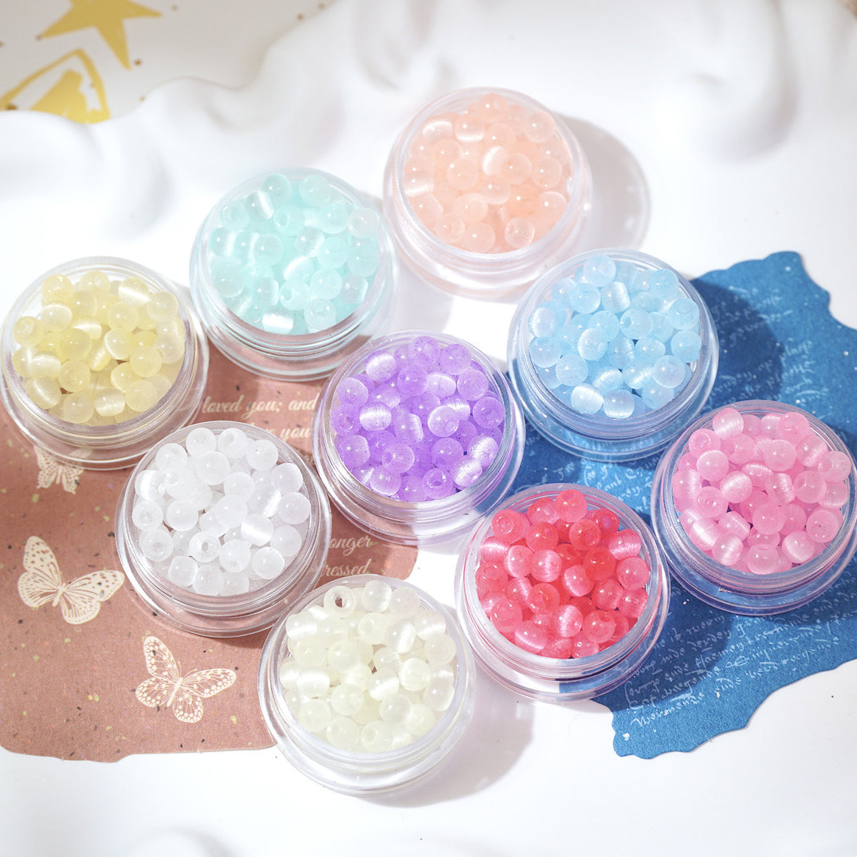 Assorted small containers of colorful beads on a decorative background