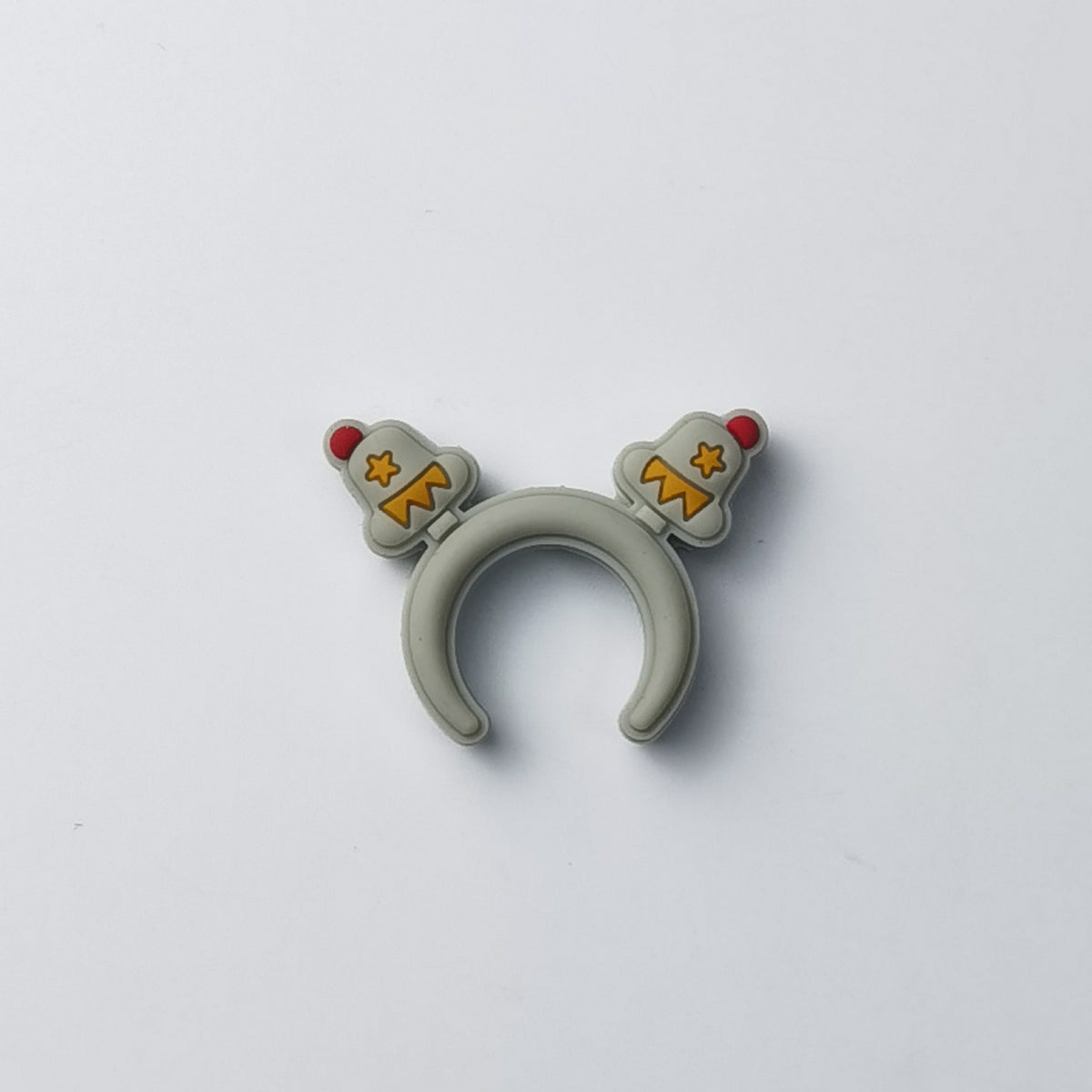Light gray silicone teether with two small red and yellow astronaut-themed charms, on a plain background
