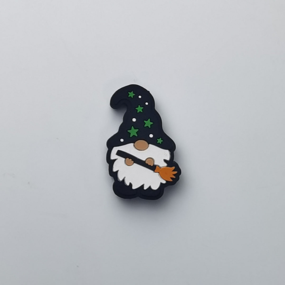 Gnome silicone focal bead with black hat, green stars, white beard, and orange broom