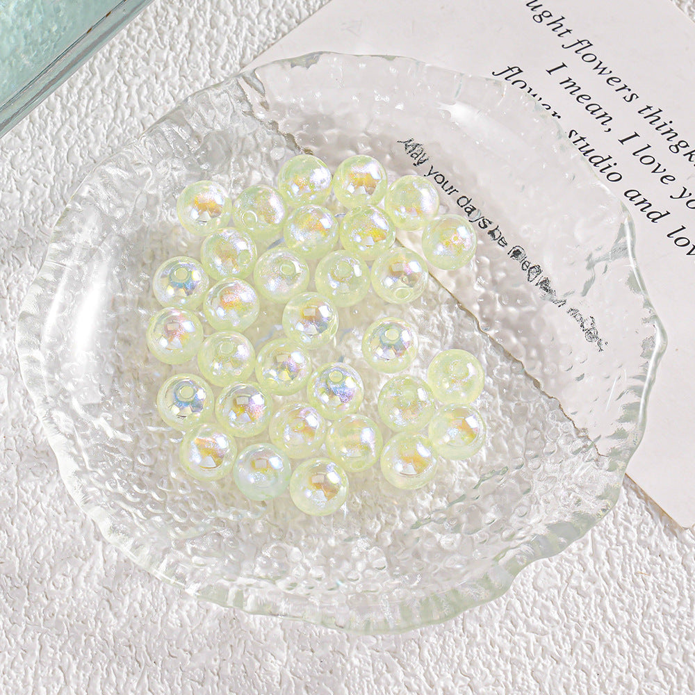 Cluster of iridescent translucent pale green beads with rainbow reflections