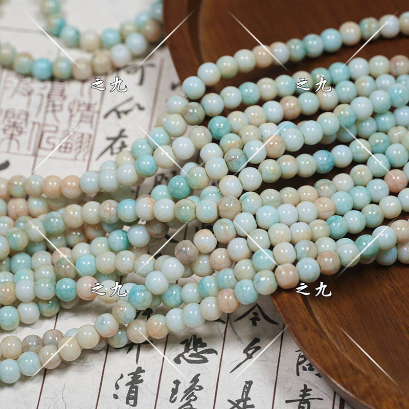 Multiple strands of polished round porcelain beads in aqua, mint, cream, peach