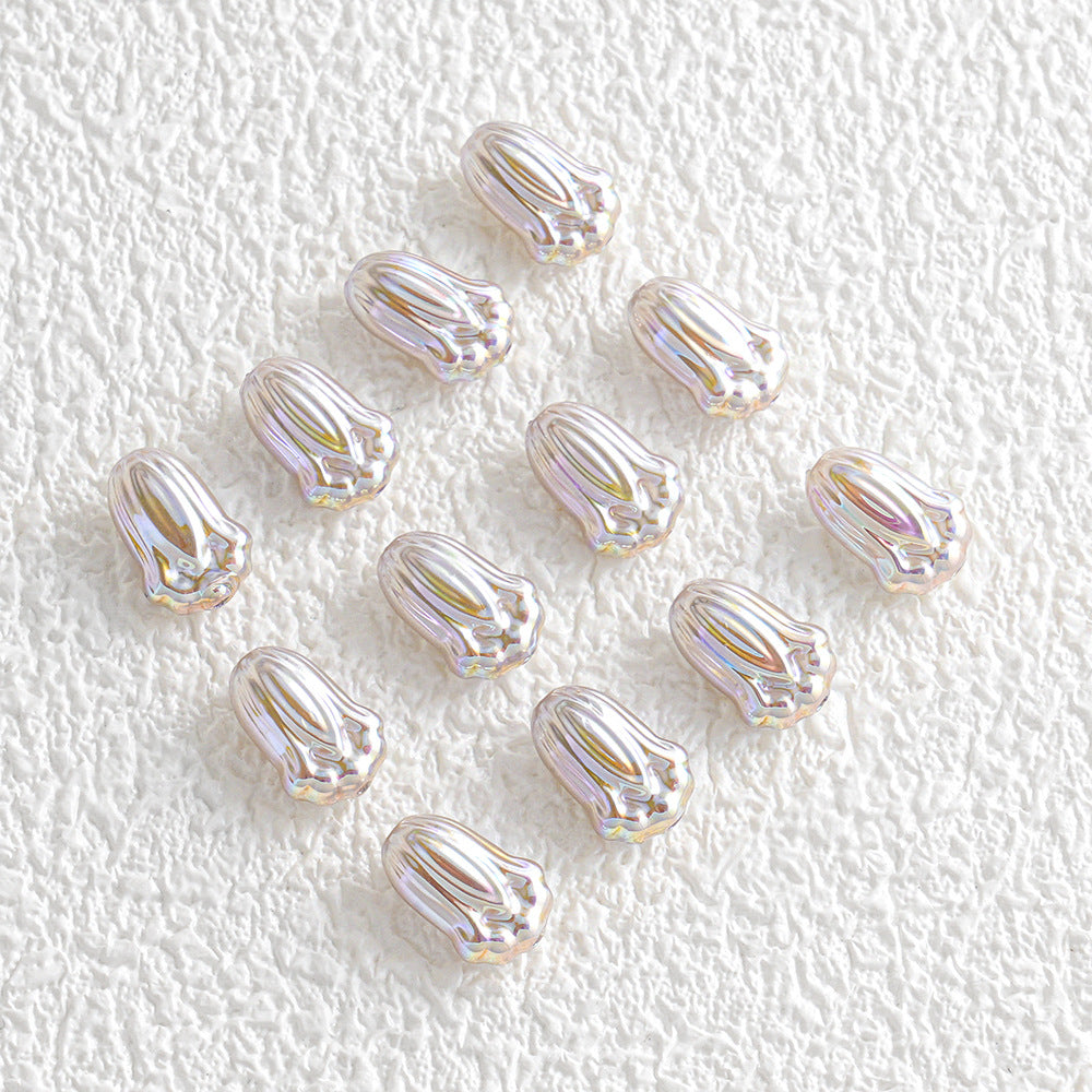 Twelve small iridescent silver tulip-shaped beads in a loose diamond pattern