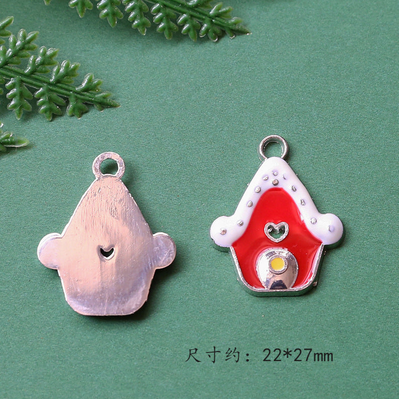 Two small decorative pendant charms on green background, plain metallic
