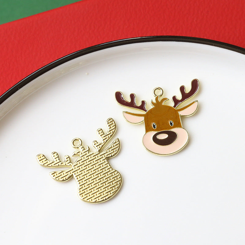 Two small deer-shaped charms on white plate with red and green background