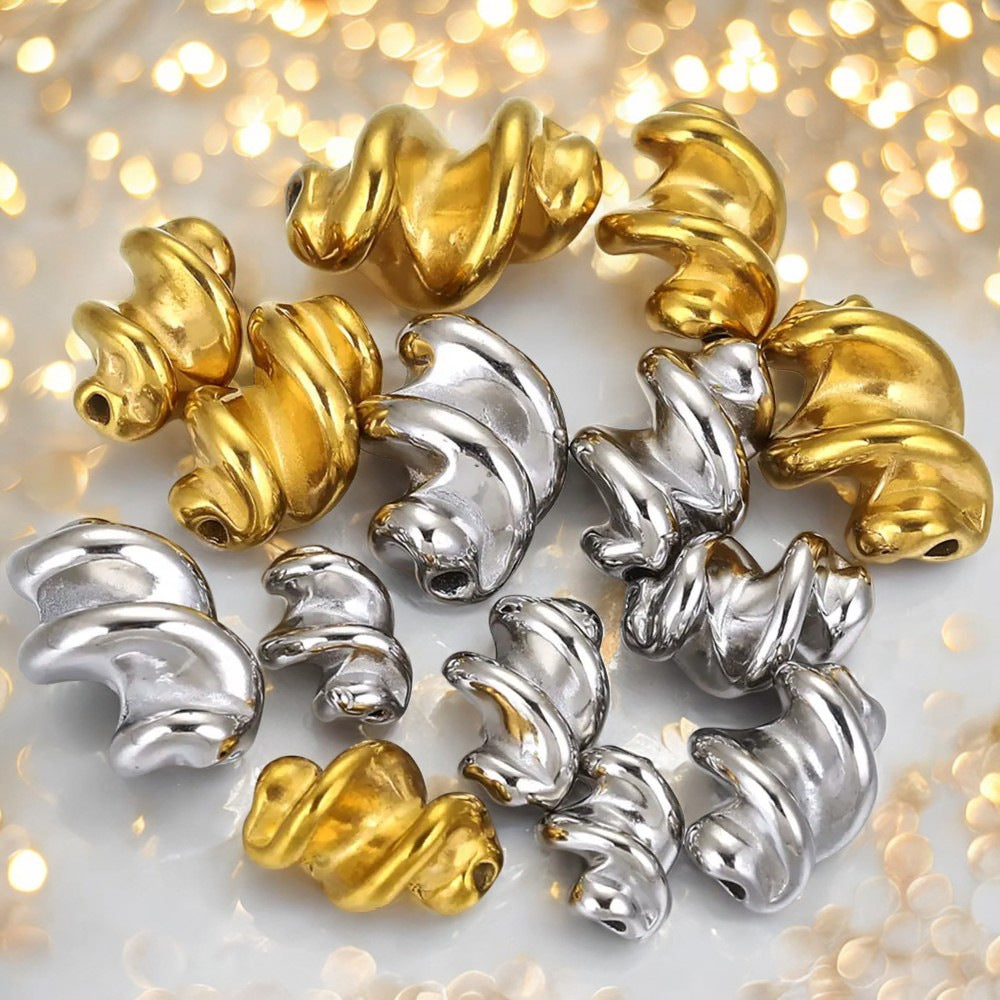 Gold and silver twisted stainless steel spiral spacer beads on glittery background