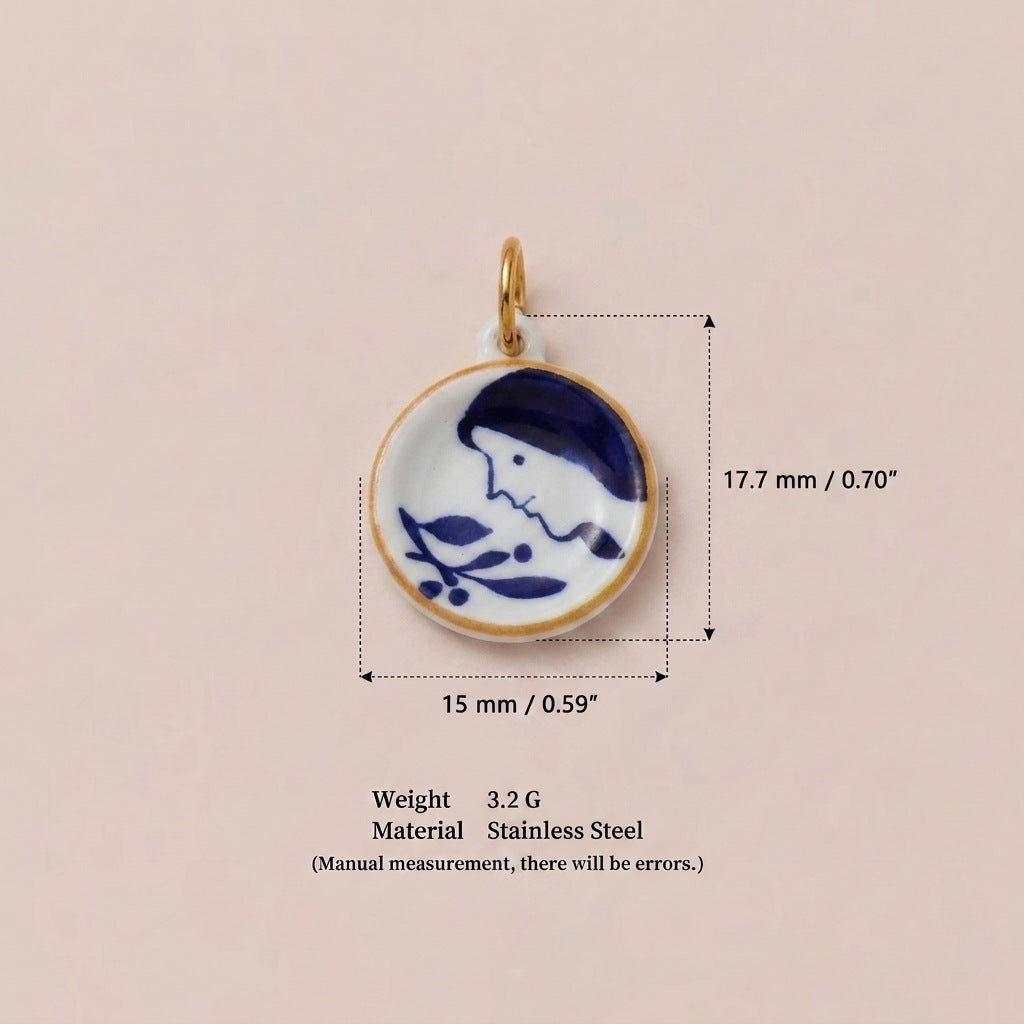 Round pendant charm with blue and white girl and floral design, shown with size measurements.
