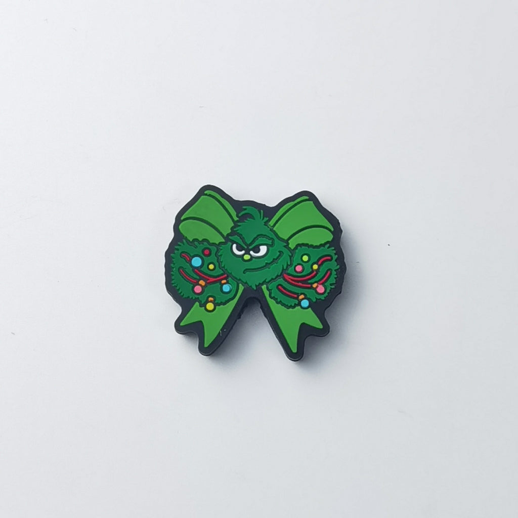 Green Grinch bow silicone focal bead with Grinch face center and wreath circles with colorful ornaments