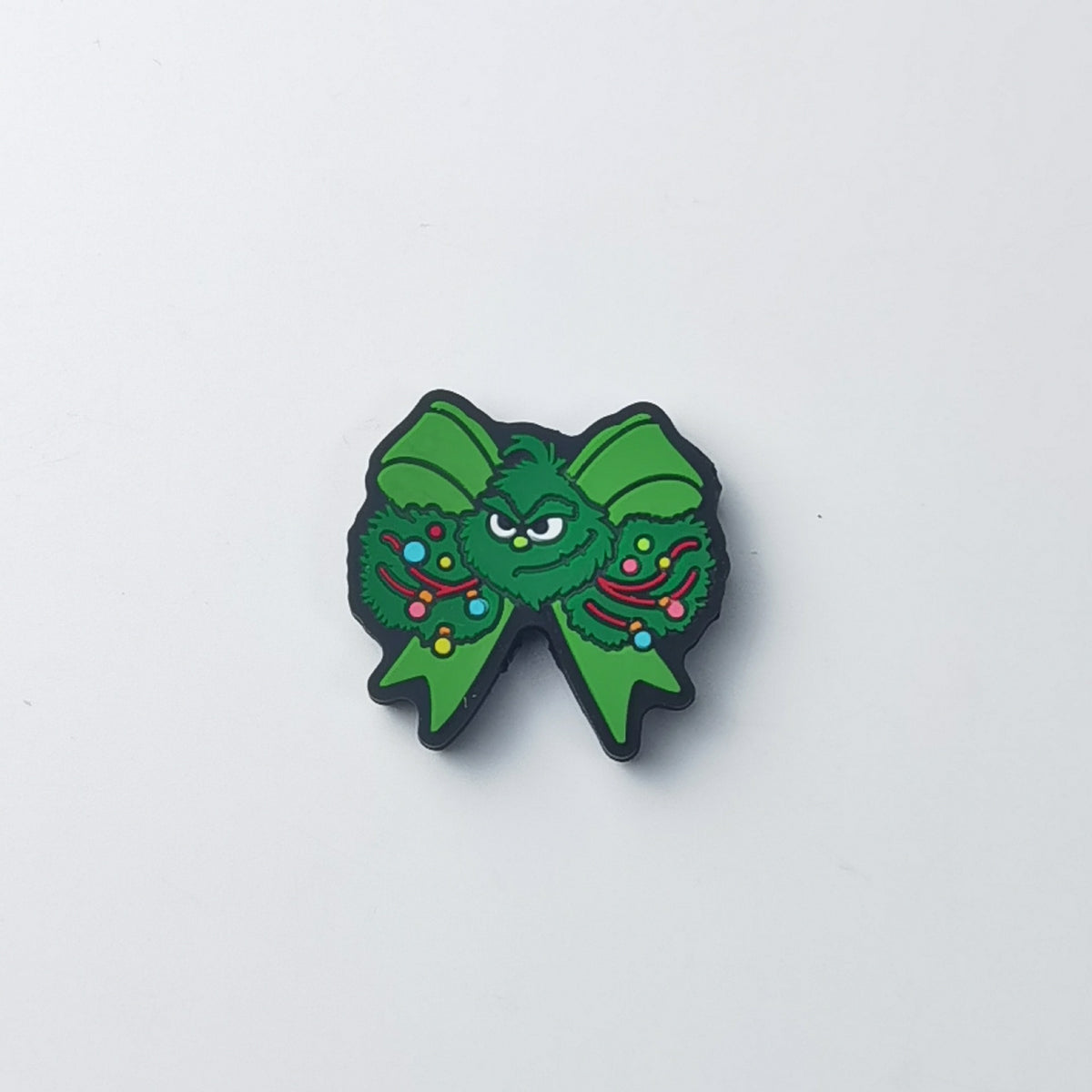 Green Grinch bow silicone focal bead with Grinch face center and wreath circles with colorful ornaments