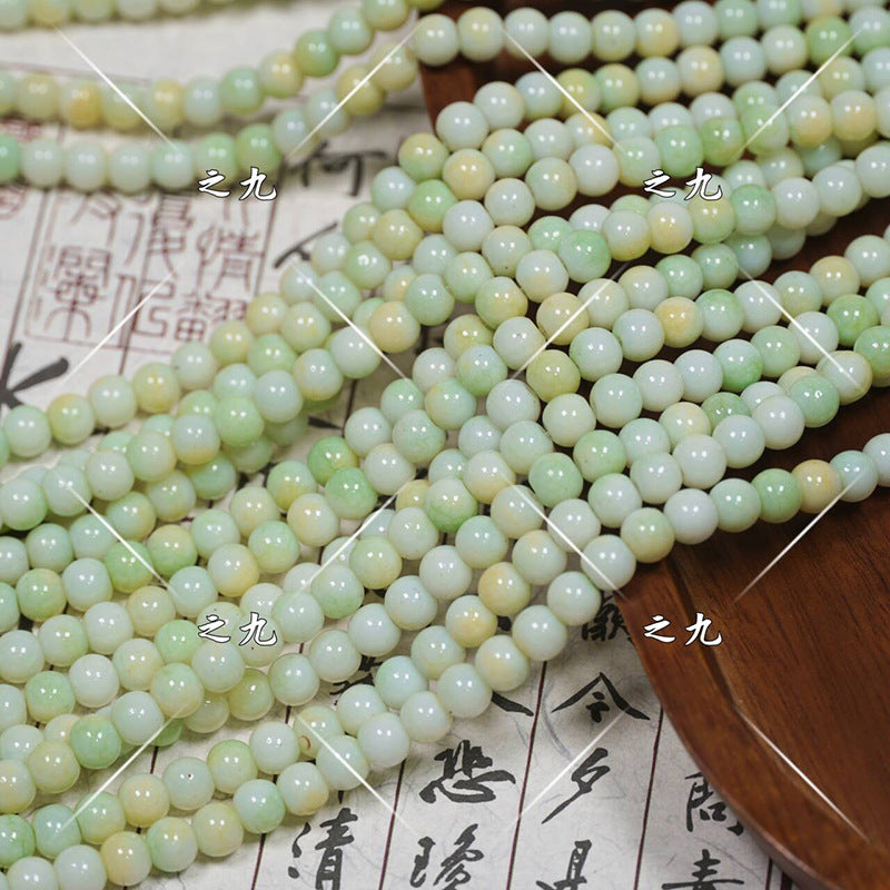 Multiple strands of round jade-like porcelain beads in pale green and soft yellow