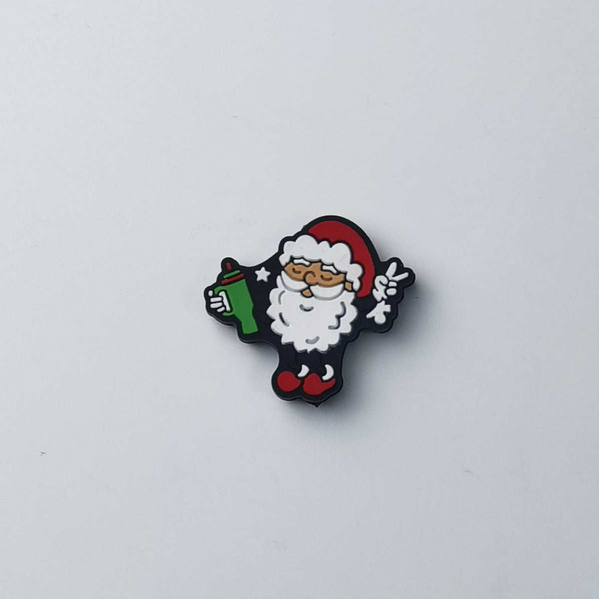 Santa Claus silicone focal bead with white beard and red hat, holding green gift and making peace sign
