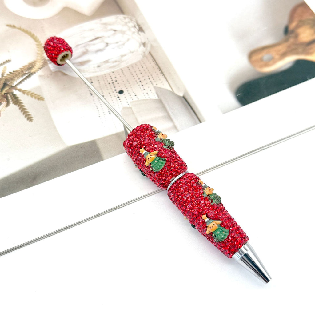 Red rhinestone pen with strawberry-shaped top and holiday embellishments.