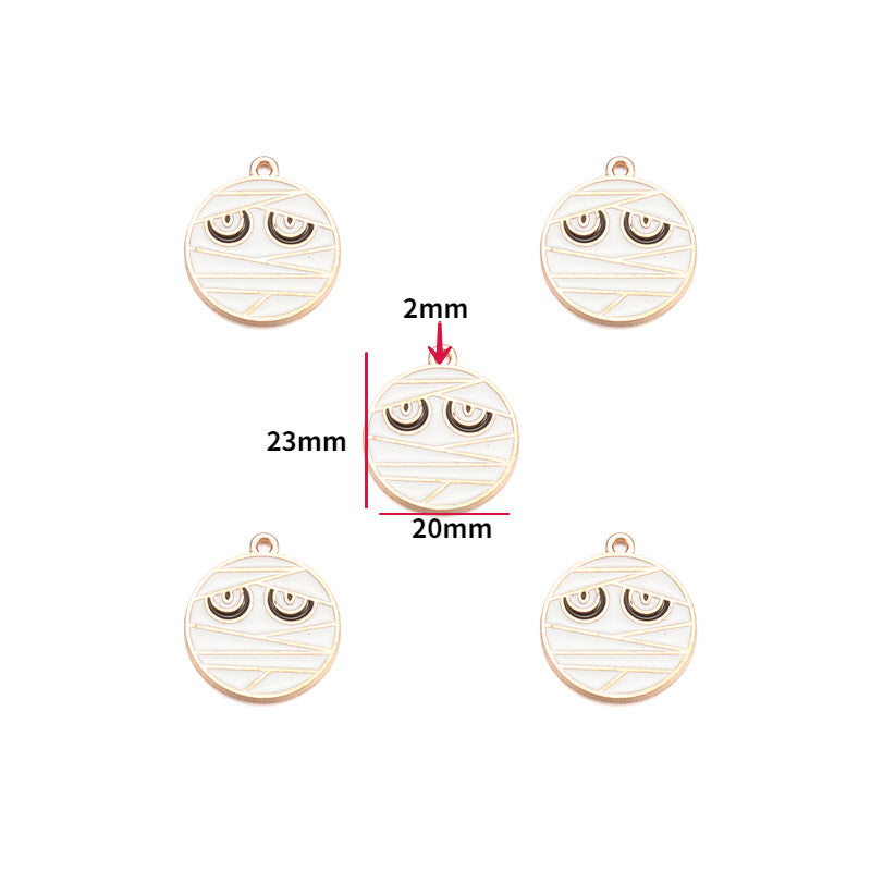 Five round mummy pendant charms with engraved eyes on white, center charm annotated 20mm by 23mm.