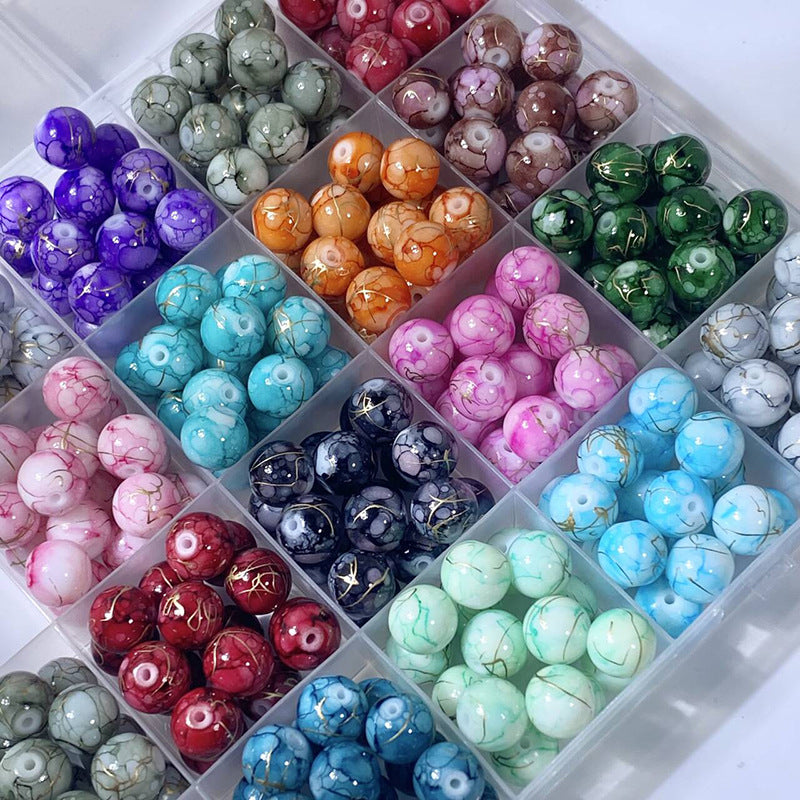 Compartment tray of marbled brushed gold-silk glass beads in assorted colors