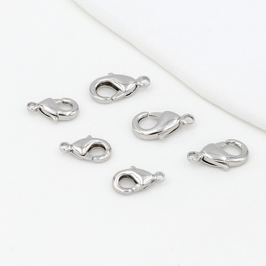 Silver teardrop lobster clasps on a white background