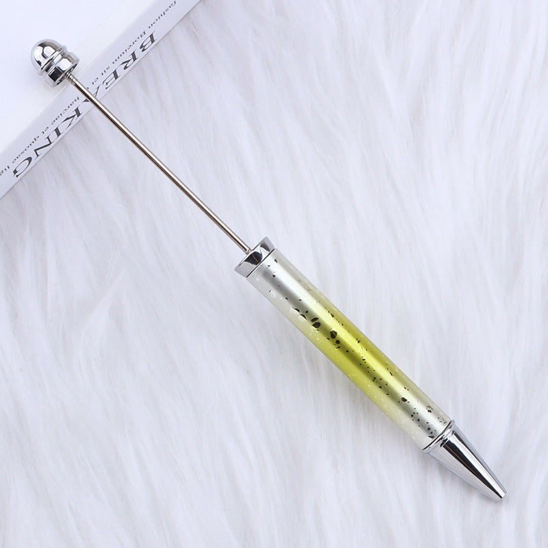 Metallic ombre beadable pen with yellow and silver design on a white background.
