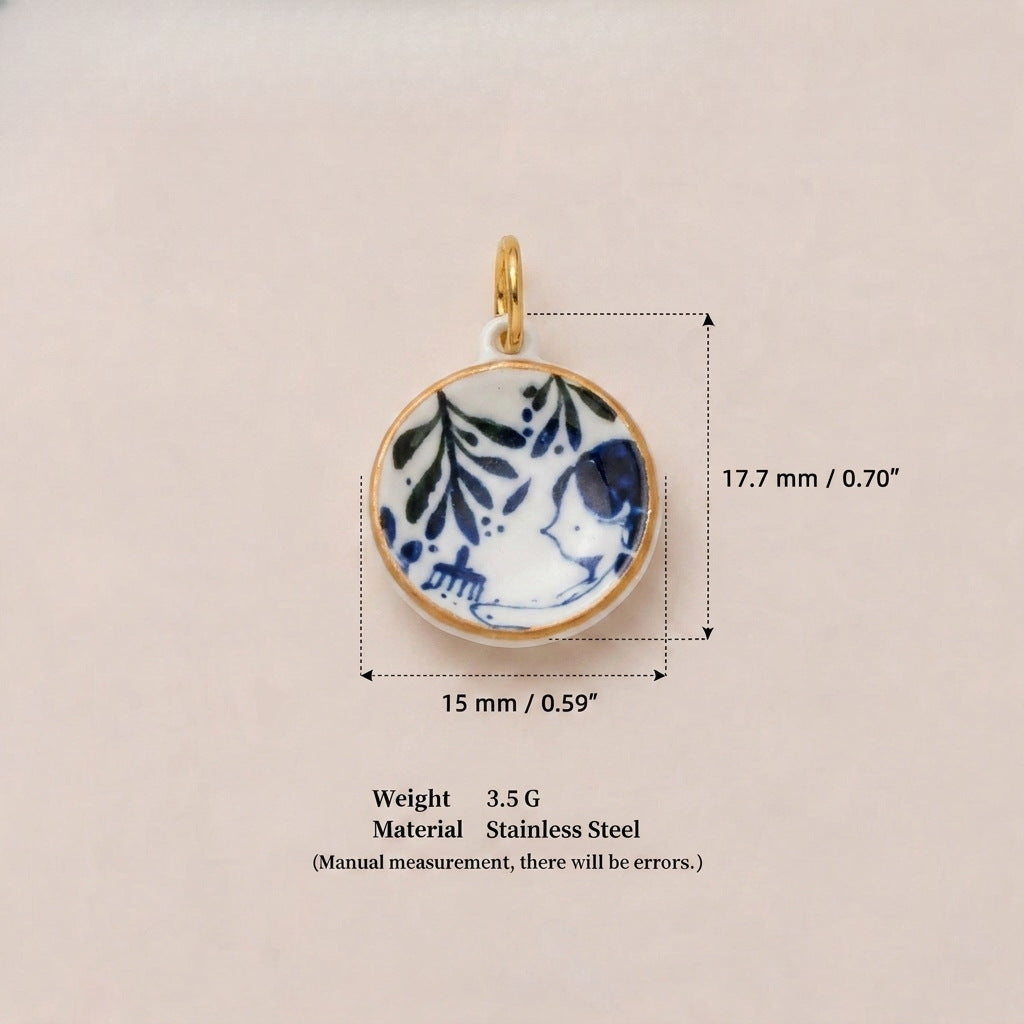 Round pendant charm with blue and white floral design, shown with size measurements.