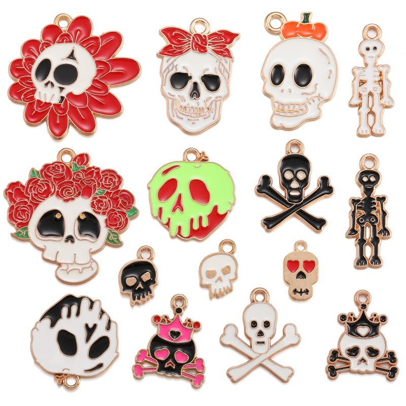 A set of 15 Halloween-themed enamel charms and pendants on a plain white background, featuring skulls, skeletons, flowers, and crossed bones in various colors.