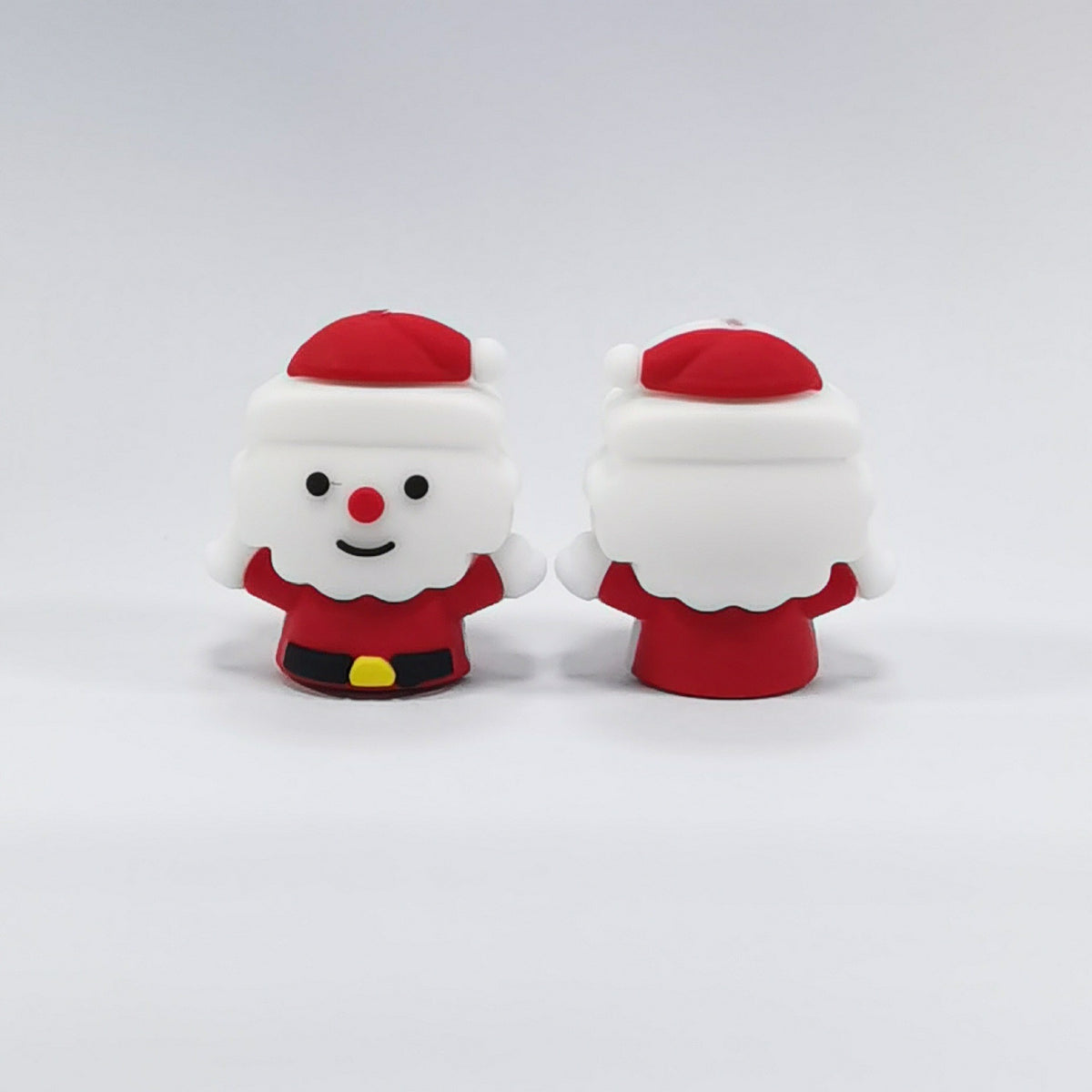 Two Santa Claus silicone focal beads in red suits with white beards, one facing front and one facing back