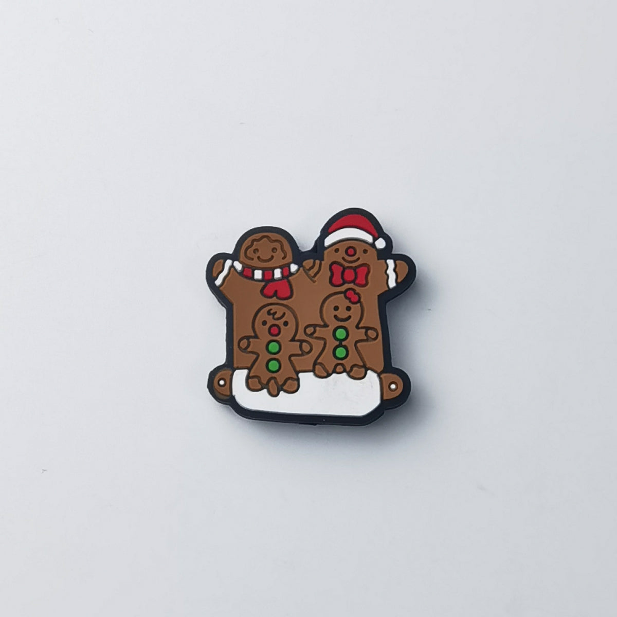 Gingerbread people silicone focal bead: one in red Santa hat, one with striped scarf, two small with green buttons