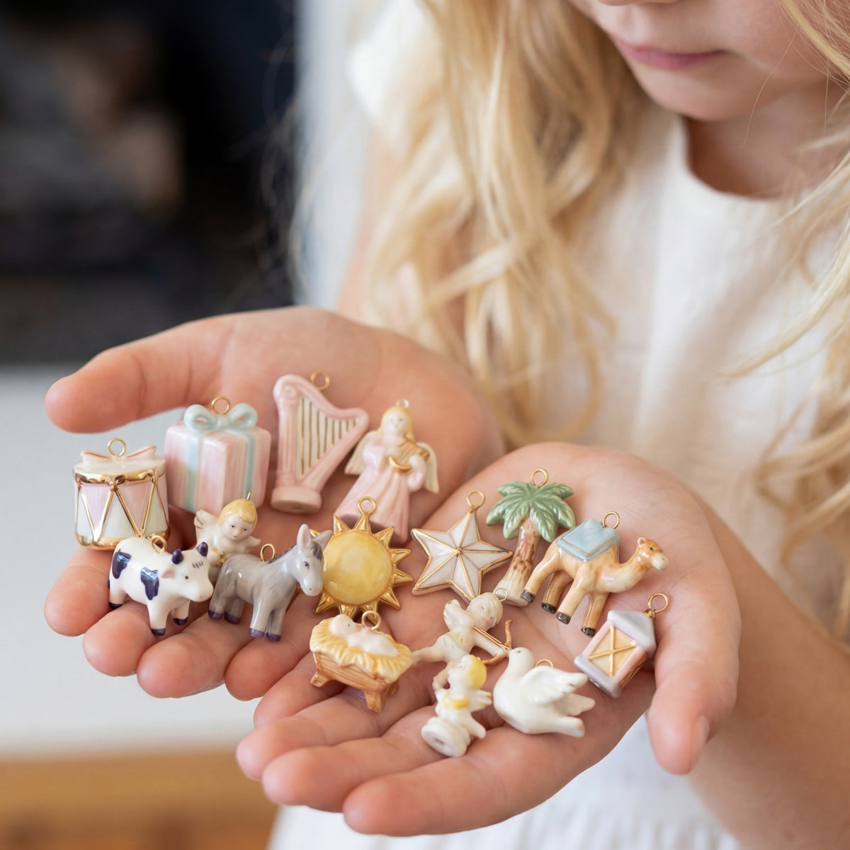 Child holding small decorative figurines in their hands