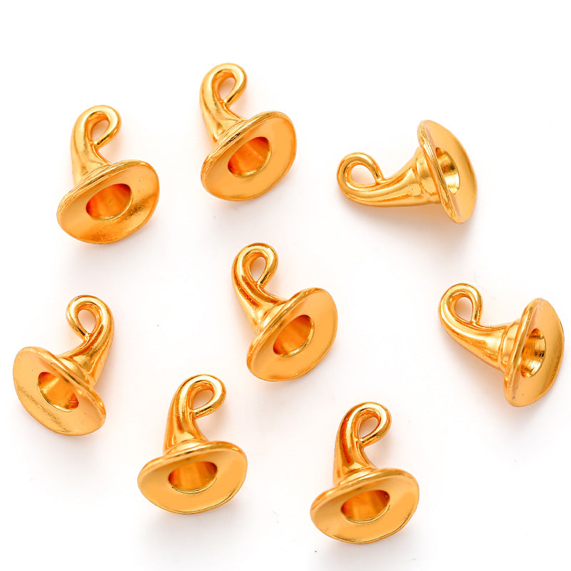 Nine gold metal witch hat charms with pointed tops on a white background.
