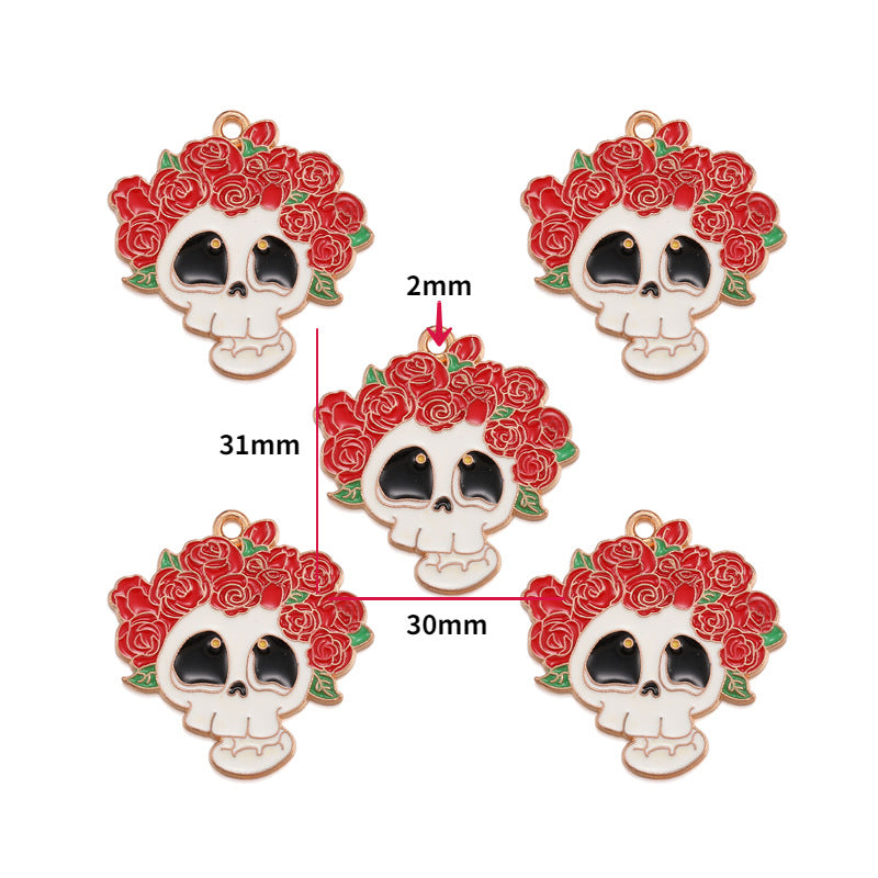 Five enamel skull charms with red rose crowns on a white background