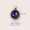 Blue and gold oval celestial pendant charm with star design and size measurements on white background.