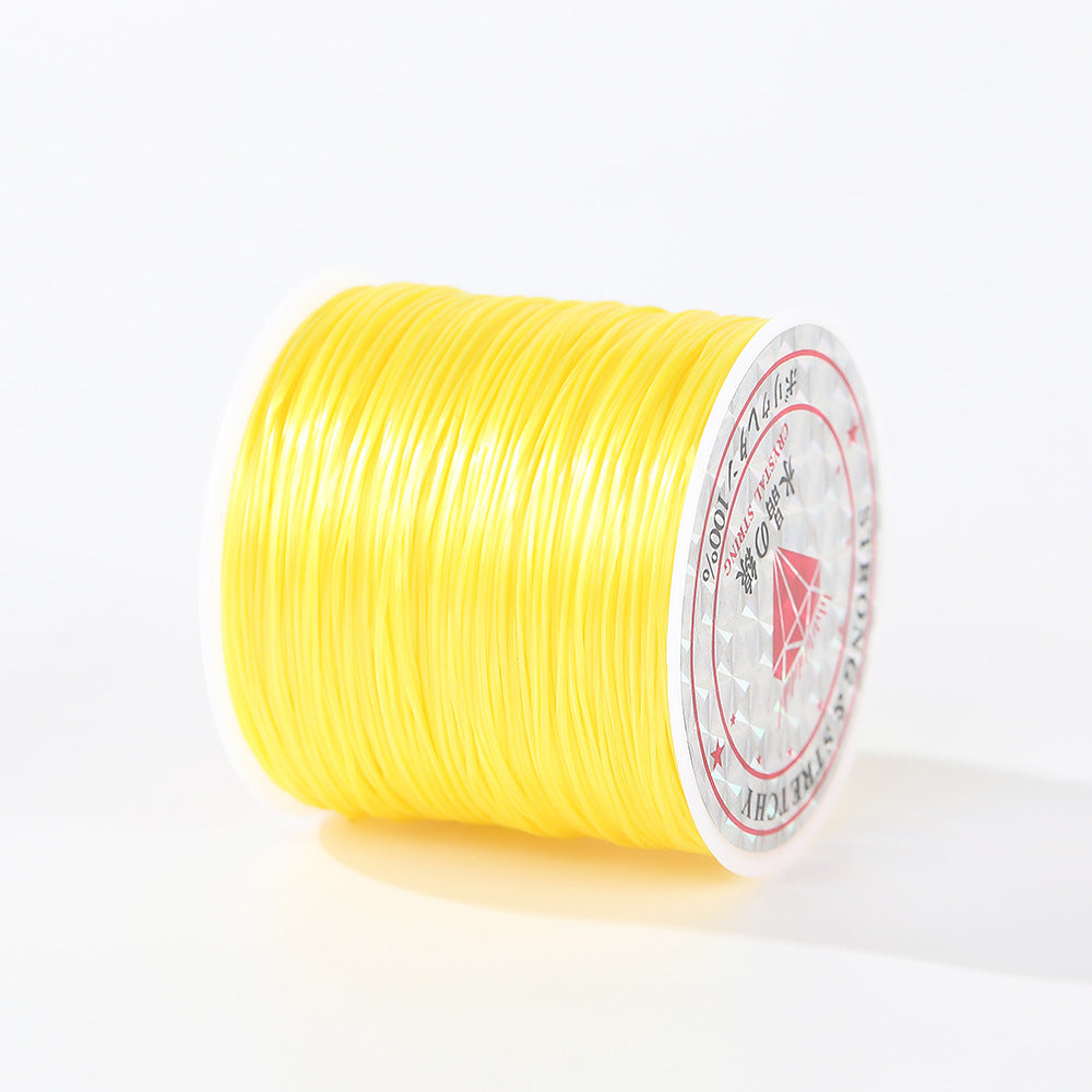 Bright yellow 0.8mm flat elastic beading cord spool at an angle, white label with red text on the end, white background