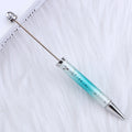 Turquoise and silver ombre beadable pen on a white background.