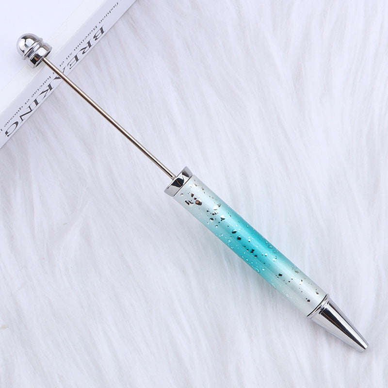 Turquoise and silver ombre beadable pen on a white background.