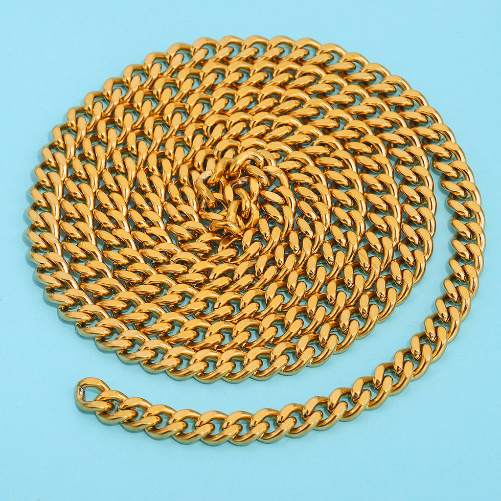 Gold-plated NK Cuban curb chain coiled in a spiral on a light blue background