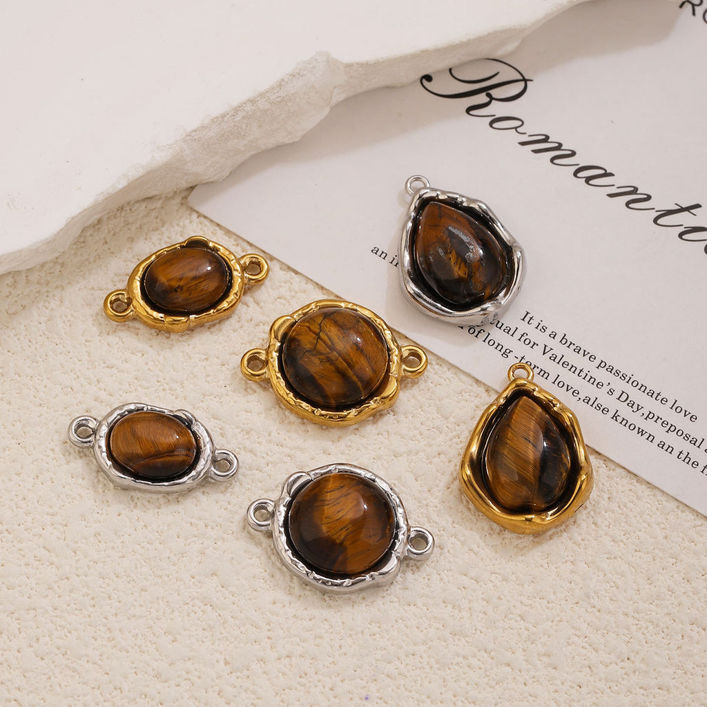 Six tiger's eye connector charms and pendants, oval round teardrop shapes, gold and silver settings, cream textured surface