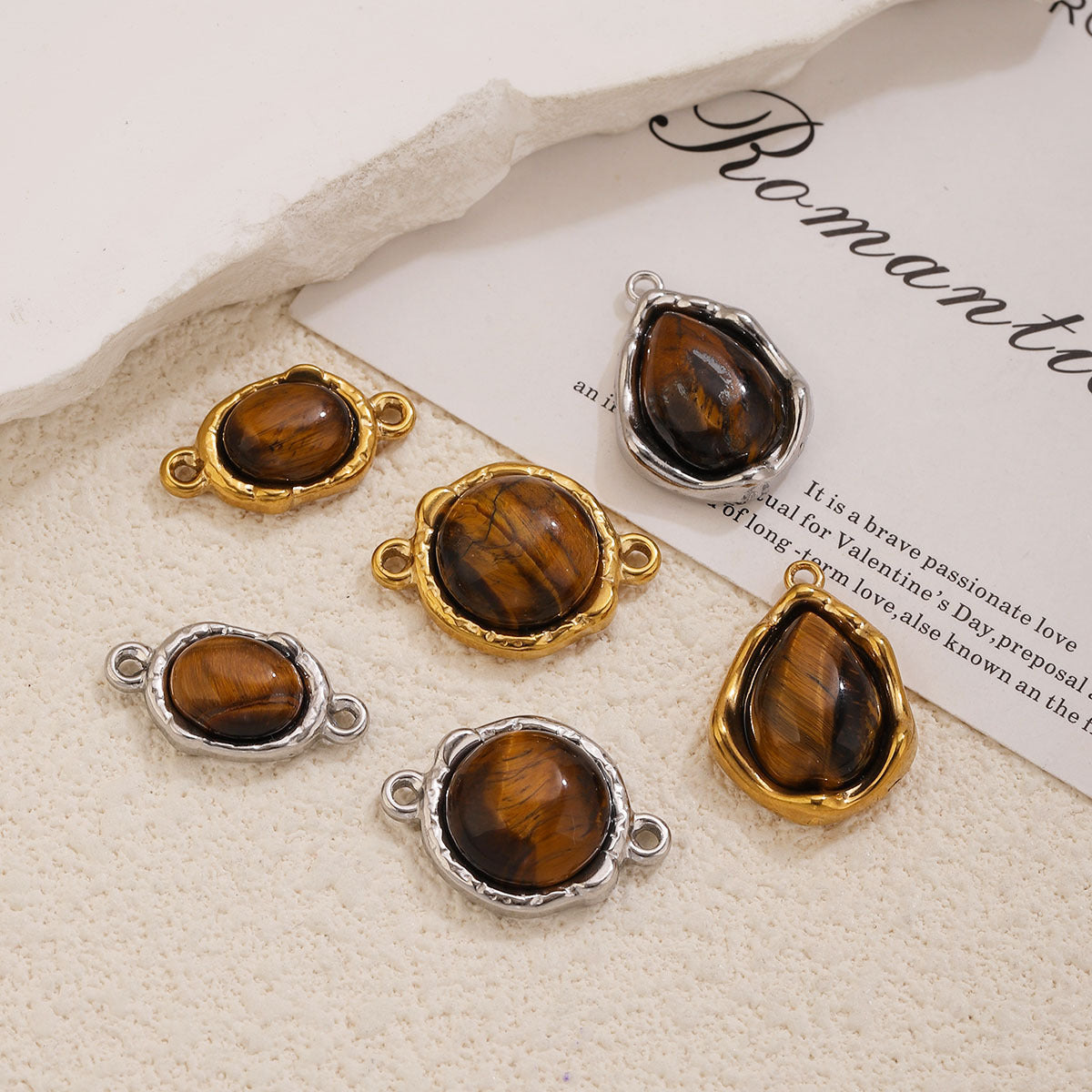 Six tiger's eye connector charms and pendants, oval round teardrop shapes, gold and silver settings, cream textured surface