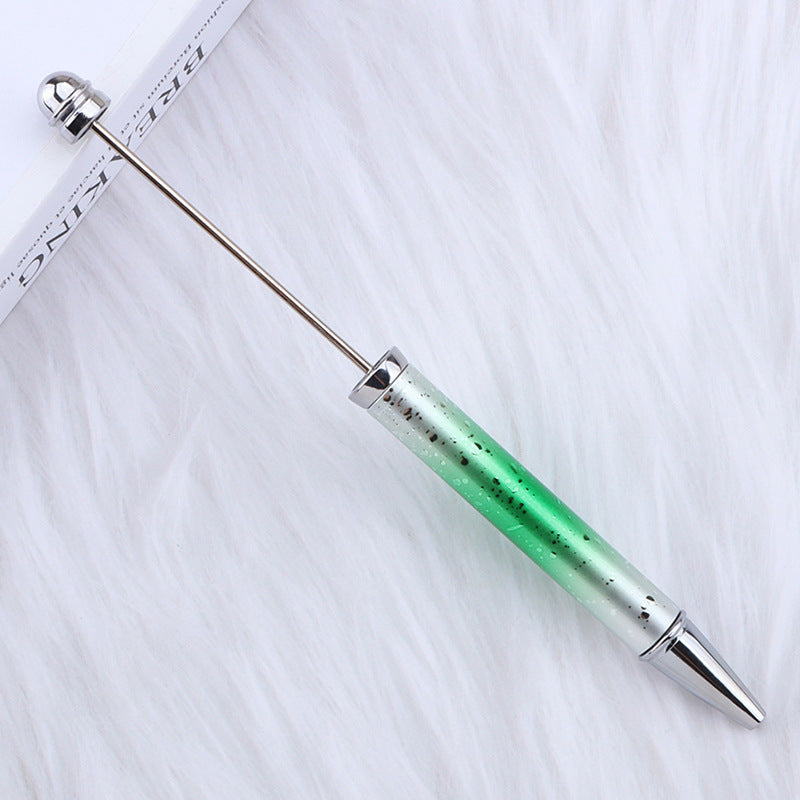Green and silver ombre beadable pen on a white background.