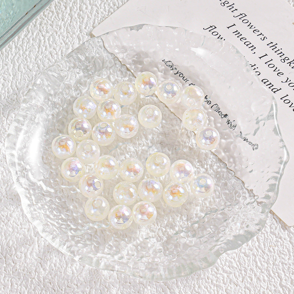 Round iridescent pearl-like beads with tiny yellow star accents