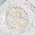 Round iridescent pearl-like beads with tiny yellow star accents