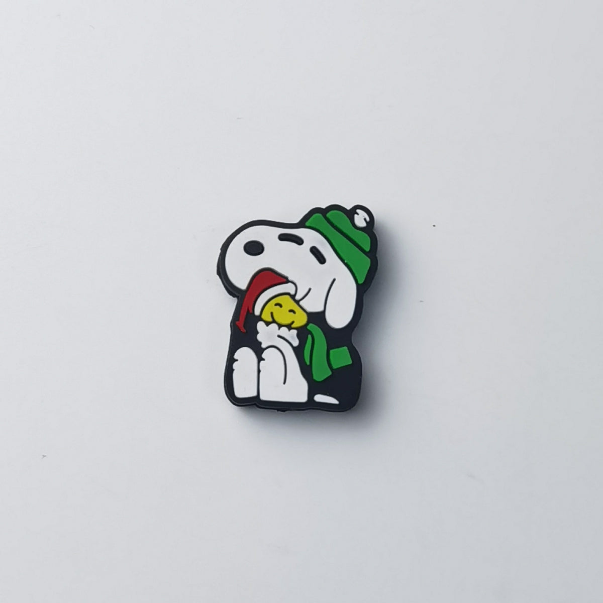Snoopy silicone focal bead in green knit hat and scarf, holding yellow Woodstock wearing red Santa hat