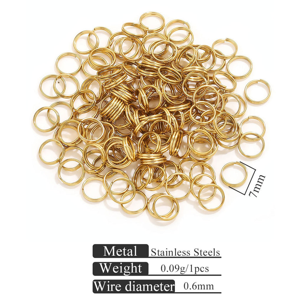 Small gold-colored stainless steel split rings on white with 7mm size indicator