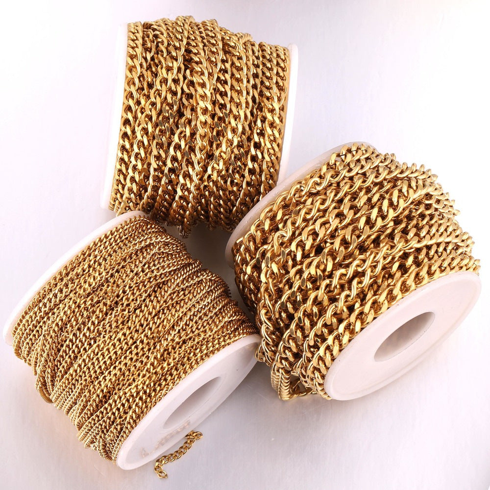 Three spools of gold-plated NK Cuban curb chain, one upright and two lying down