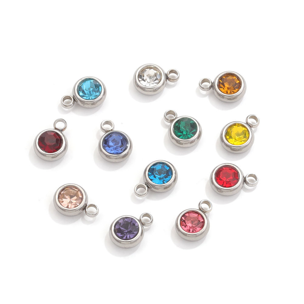 Twelve silver-tone round crystal birthstone charms, assorted colors