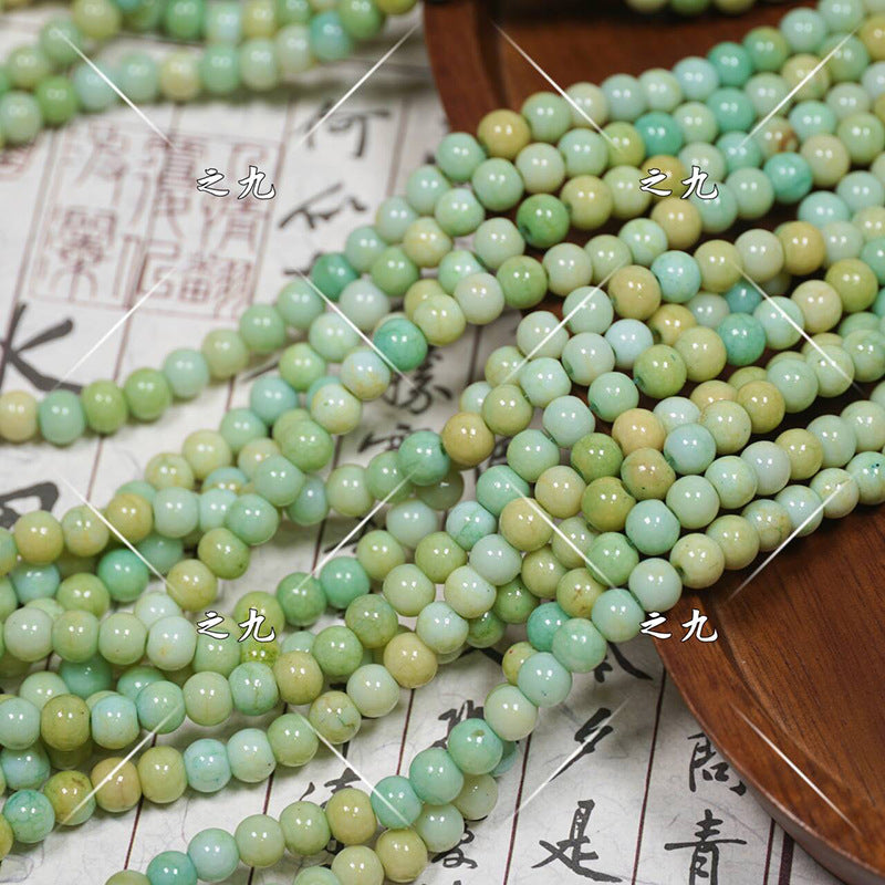 Multiple strands of round jade-like porcelain beads in mint green, pale yellow, aqua