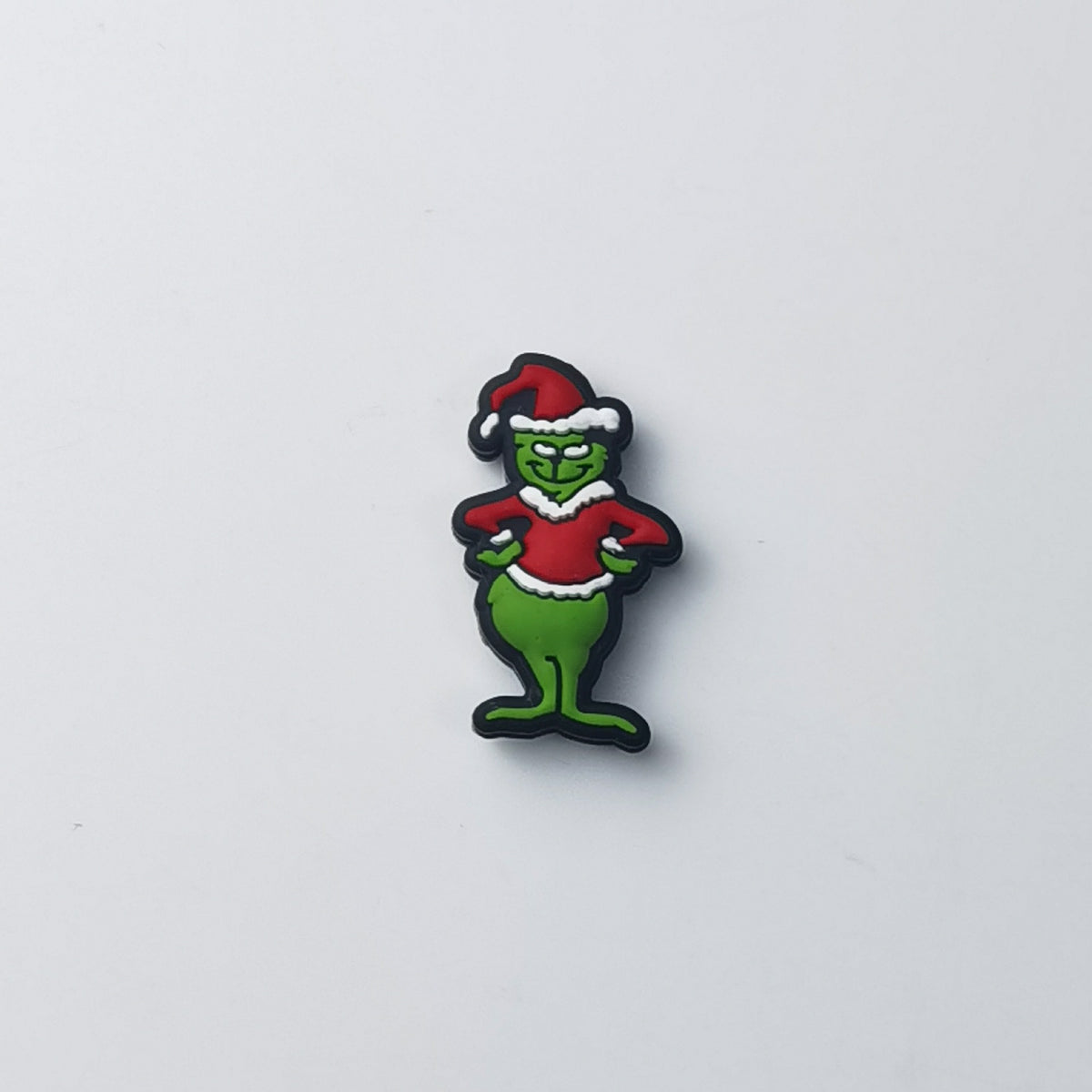 Green Grinch silicone focal bead wearing red Santa hat with white trim and red sweater
